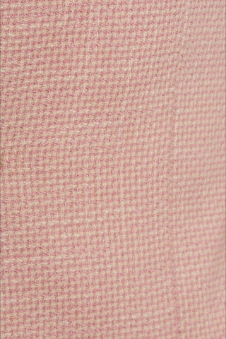 Close-up of a textured pink fabric with a subtle pattern