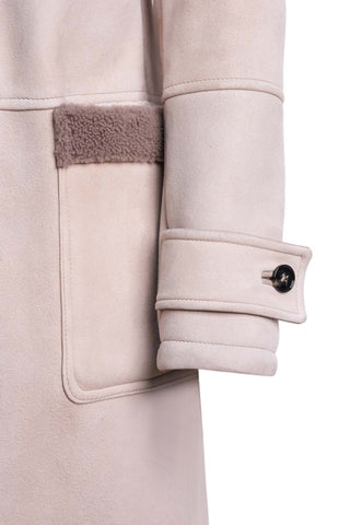 Close-up of a beige coat with a button and fleece trim on a white background